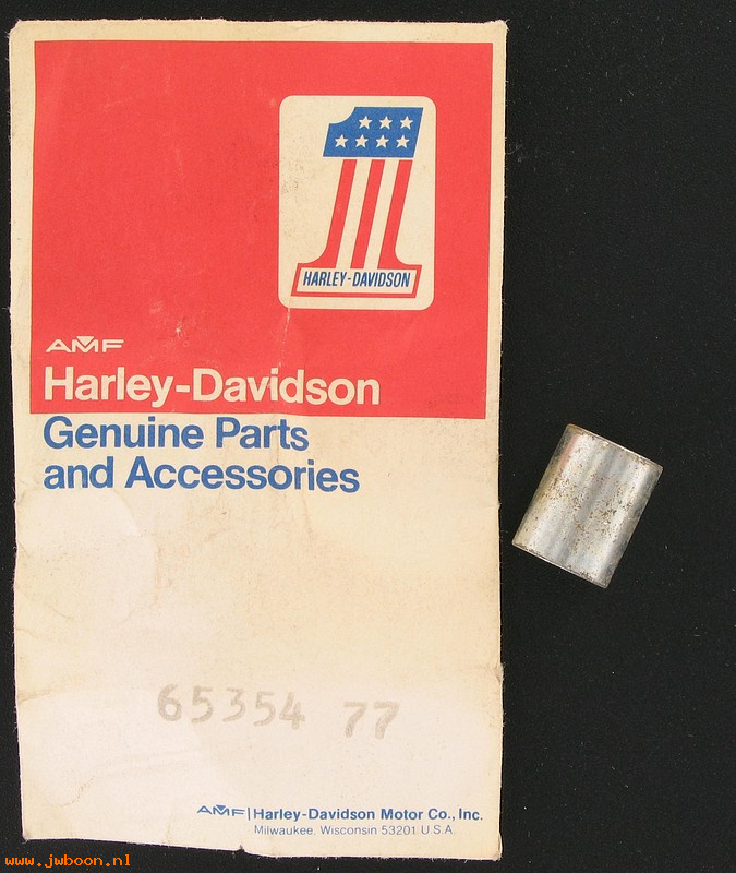   65354-77 (65354-77): Spacer, muffler support tube to frame - NOS - FLHS 1977. FX,FXE